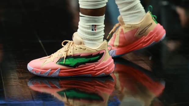 Portland Trail Blazers guard Scoot Henderson's pink and green PUMA shoes.
